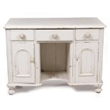 A VICTORIAN WHITE PAINTED PINE DRESSING TABLE with turned knob handles to the three drawers and