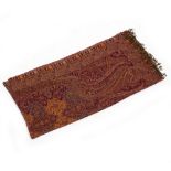 A DARK RED GROUND FLORAL SHAWL with paisley ornament and fringed ends, 262cm x 133cm Condition: of