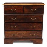 A HARDWOOD CHEST OF TWO SHORT AND THREE LONG DRAWERS with brass handles and raised on bracket