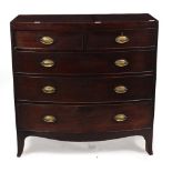 A GEORGE III MAHOGANY BOW FRONTED CHEST OF TWO SHORT AND THREE LONG DRAWERS with splayed bracket
