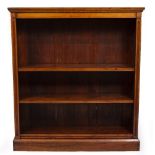 A 19TH CENTURY WALNUT OPEN FRONTED DWARF BOOKCASE with three adjustable shelves and standing on a