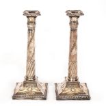 A PAIR OF 19TH CENTURY SILVER PLATED CANDLESTICKS of classical column form, the column shafts
