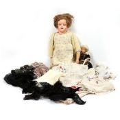 A MID 20TH CENTURY DOLL with composite head and articulated kid leather torso (damages),