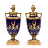 A PAIR OF TABLE LAMPS constructed from French porcelain urns, of blue ground with parcel gilt