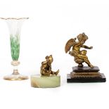 AN ANTIQUE CAST BRASS SMALL SCULPTURE OF A WINGED PUTTI mounted on a cast iron base, 11cm high