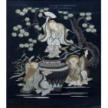 AN EMBROIDERED JAPANESE BLACK SILK PANEL depicting figures dancing around a cauldron beneath pine