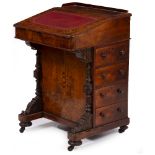 A VICTORIAN WALNUT DAVENPORT DESK with hinged galleried lid to the top enclosing compartments