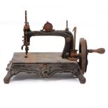 AN ANTIQUE CAST IRON SEWING MACHINE the base, 34cm wide x 22cm deep x standing 27cm high overall