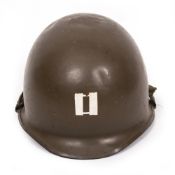 AN AMERICAN STYLE GREEN PAINTED MILITARY TIN HELMET the rim stamped B855R3, 23.8cm wide Condition: