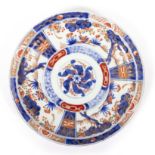 AN IMARI PORCELAIN DISH with three feet, 24.5cm diameter x 4cm high Condition: one foot has been