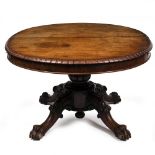 A WILLIAM IV MAHOGANY EXTENDING DINING TABLE with a carved and reeded stem and four scrolling legs