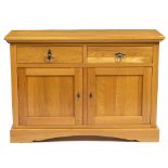 A MODERN LIGHT OAK SIDE CABINET by Frank Hudson, having two drawers above two panelled doors and