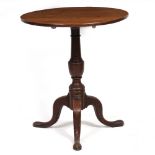 A 19TH CENTURY MAHOGANY TILT TOP TRIPOD TABLE 65cm diameter x 75cm high Condition: a split to the