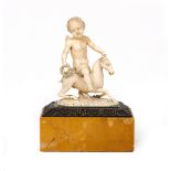 AN ANTIQUE POSSIBLY ITALIAN CARVED IVORY FIGURE OF A PUTTI RIDING ON THE BACK OF A GOAT mounted on a