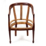 AN EARLY 19TH CENTURY MAHOGANY BERGERE CHAIR FRAME with square tapering legs and spade feet, 60cm