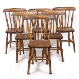 A SET OF SIX BEECH AND ELM SPINDLE BACK KITCHEN CHAIRS with turned supports, each 35cm wide x 40cm