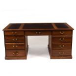 A MODERN HARDWOOD PEDESTAL DESK with nine drawers around the central kneehole and cupboard doors