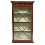 A MAHOGANY HANGING BOOKCASE with astragal glazed single door enclosing adjustable shelves, 70cm wide