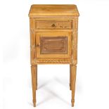 A FRENCH PINE BEDSIDE CABINET with a single drawer above a cupboard, raised on turned fluted legs,