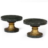 A PAIR OF CIRCULAR FOOTED STANDS with turned painted faux marble tops and bases and chased and