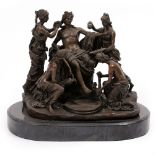 A DECORATIVE BRONZE signed M Mercie, depicting a classical god being washed by maidens, all