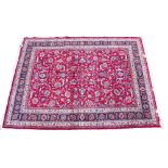 A LATE 20TH CENTURY MIDDLE EASTERN RED GROUND RUG with styalised foliate decoration and a