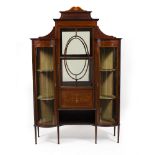 AN EDWARDIAN MAHOGANY DISPLAY CABINET with three glazed doors, two with bow fronts, all standing