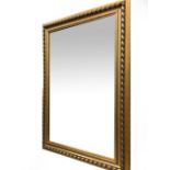 A CONTEMPORARY GILDED PINE FRAMED RECTANGULAR WALL MIRROR with bevelled glass, 76.5cm x 106cm