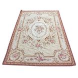 AN AUBUSSON NEEDLEPOINT CARPET with floral decoration, 144cm x 244cm Condition: moth damage to the