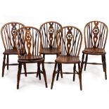 A MATCHED SET OF TEN 19TH CENTURY ASH AND ELM WHEEL BACKED KITCHEN CHAIRS to include two