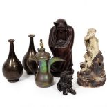 A JAPANESE EARTHENWARE POTTERY FIGURE of a man in a cloak, 34cm high; a metal figure of a dog of fo;