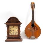A MANDOLIN 63cm long overall together with Continental walnut mantle clock, 36.5cm high (2)