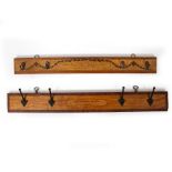 TWO SETS OF HANGING COAT HOOKS constructed from the name boards of Georgian square pianos, one