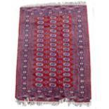 A MID TO LATE 20TH CENTURY EASTERN BOKHARA RED GROUND WOOLLEN RUG 184cm x 125cm Condition: in good