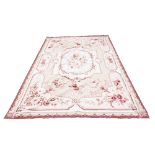 AN AUBUSSON NEEDLEPOINT RUG with floral decoration, 164cm x 262cm Condition: signs of moth and minor