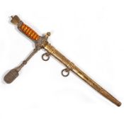 A GERMAN NAVAL OFFICER'S KRIEGSMARINE DAGGER AND SCABBARD with a gilt metal eagle and swastika