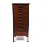 AN EARLY 20TH CENTURY HARDWOOD GRADUATED CHEST OF ELEVEN DRAWERS in the Liberty style, 59cm wide x