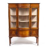 AN EDWARDIAN MAHOGANY BOW FRONTED DISPLAY CABINET with decorative inlay, two glazed doors