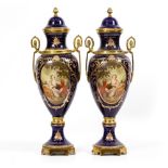 A PAIR OF SEVRES STYLE PORCELAIN VASES AND COVERS with gilt metal mounts, each vase set with a