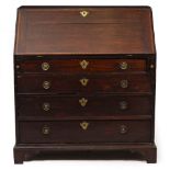 A GEORGE III OAK BUREAU with decorative stringing to the fall front enclosing a fitted interior, all