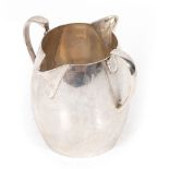 A GEORGE V SILVER CREAM JUG with twin spouts and handles, marks for Dublin 1913, 7.2cm high to the