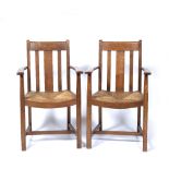 Heals pair of armchairs, light oak with rush seats one with label to underside 94cm high (2)