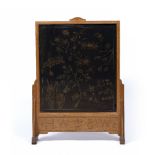 Cotswold School oak firescreen with embroidered central panel, the frieze with carved initials '