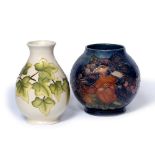 Walter Moorcroft (1917-2002) for Moorcroft Pottery 'Birds amongst fruit' globular vase on a blue
