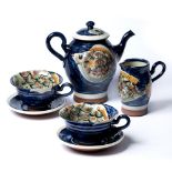 Bennett Cooper (1951-2002) studio pottery part tea set decorated with fish on blue ground, seal mark