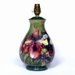 Moorcroft pottery table lamp Orchid pattern on green ground impressed marks to the base 30cm high