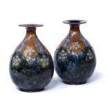 Pair of Royal Doulton Lambeth stoneware vases, one by E. Violet Hayward, the other indistinctly