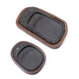 Two Duan ink stones Chinese the first of rectangular form, carved with one side with foliate