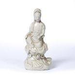 Dehua model of Guanyin Chinese, 19th Century the figure seated on a lotus base 27cm high.
