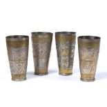 Four metal beakers Indo-Persian each of engraved tapering form 17cm high